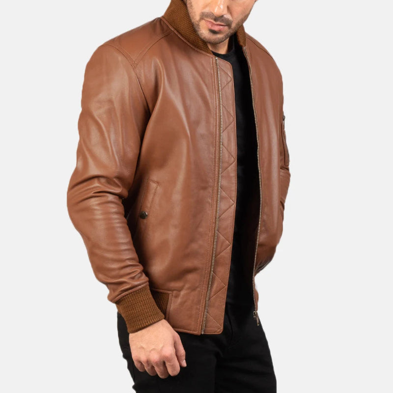 Man wearing a stylish brown leather bomber jacket featuring a ribbed collar and cuffs   