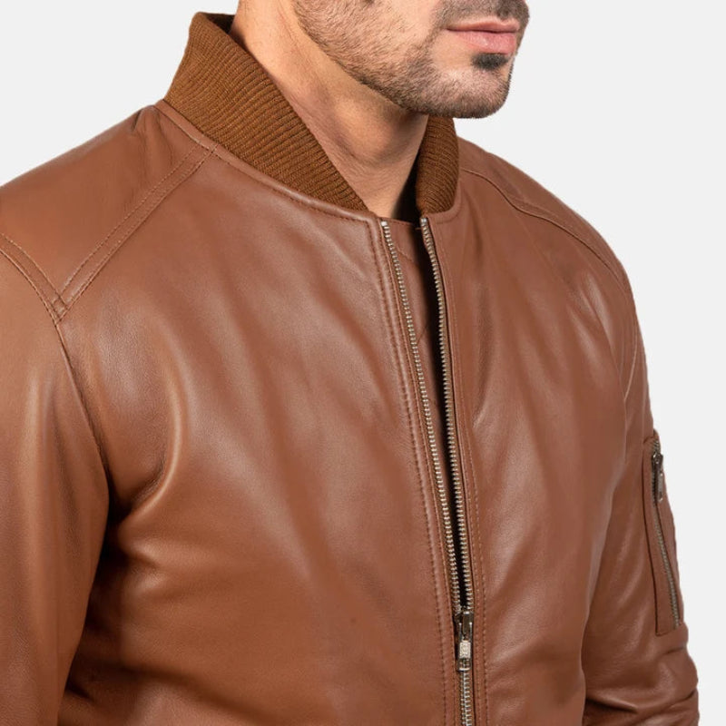 Close-up of the collar and zipper details on a men's brown leather bomber jacket