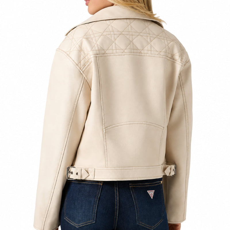 Rear view of a model wearing a beige or off-white quilted moto jacket with a buckled hem and dark jeans